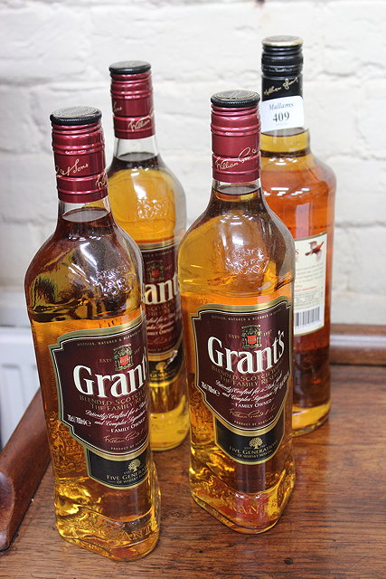 Appraisal: THREE BOTTLES OF GRANTS WHISKY a bottle of famous grouse