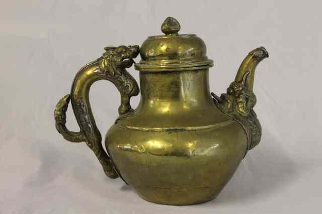 Appraisal: A TIBETAN BRASS LARGE TEAPOT with stylised mythological creature the