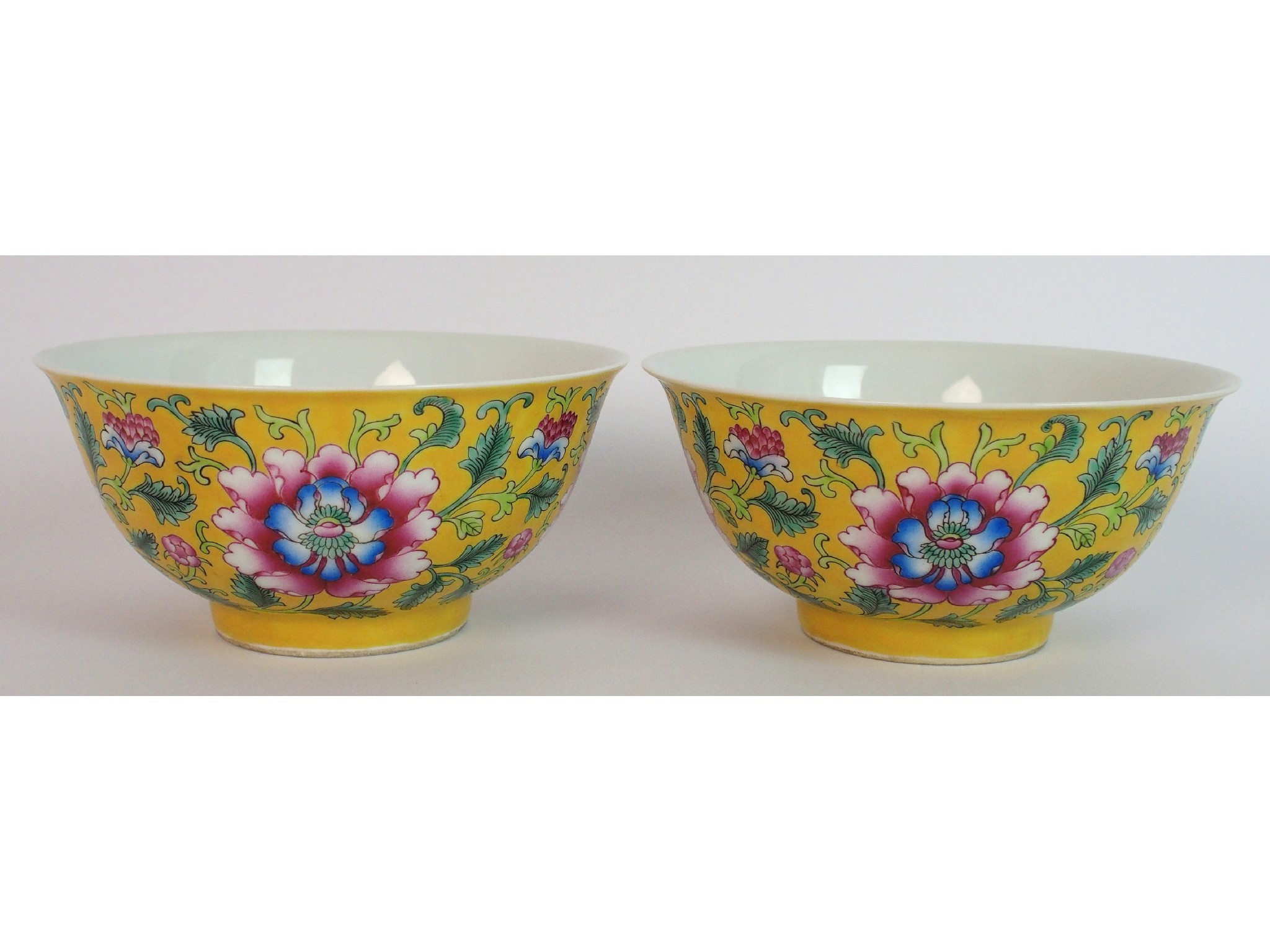 Appraisal: A pair of Chinese yellow ground bowlseach painted with chrysanthemums