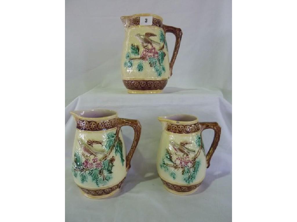 Appraisal: A graduated set of three th century style majolica jugs