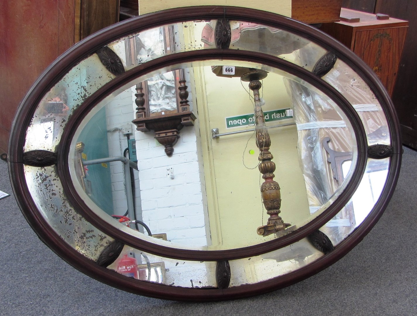 Appraisal: A th century mahogany oval segmented wall mirror with bevelled