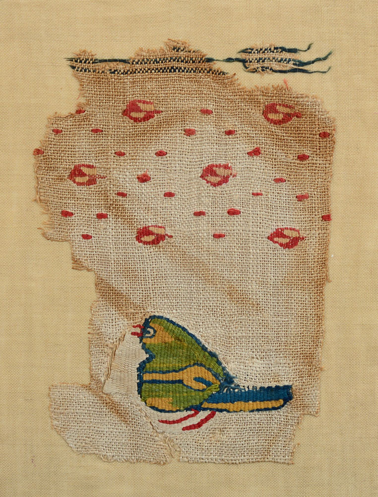 Appraisal: COPTIC TEXTILE FRAGMENT WITH A GREEN BIRD AND ROSE LATTICE