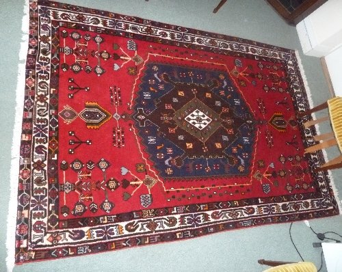 Appraisal: A modern Persian rug the central medallion on a plum