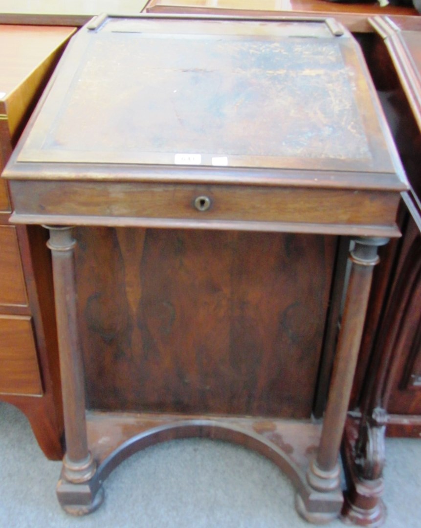 Appraisal: An early Victorian rosewood Davenport with wrap around ink drawer