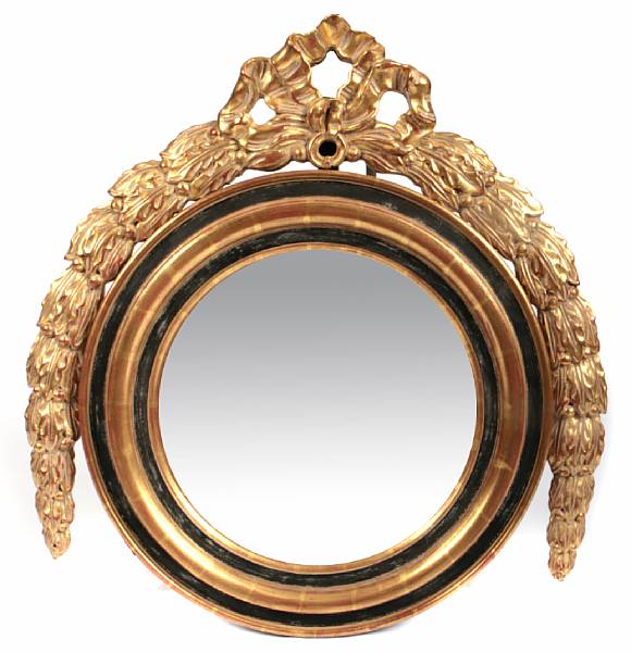 Appraisal: A Regency style parcel ebonized and giltwood convex wall mirror