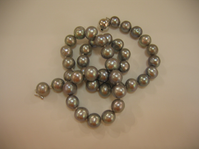 Appraisal: PEARL STRAND Cultured baroque pearl necklace with silver color Largest