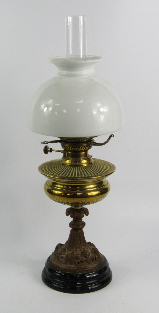 Appraisal: A Veritas cast metal oil lamp decorated with cherub's heads