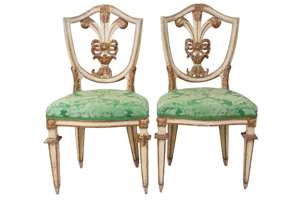 Appraisal: PAIR OF NEOCLASSIC WHITE GILT-PAINTED SIDE CHAIRSeach with shield-shaped chair