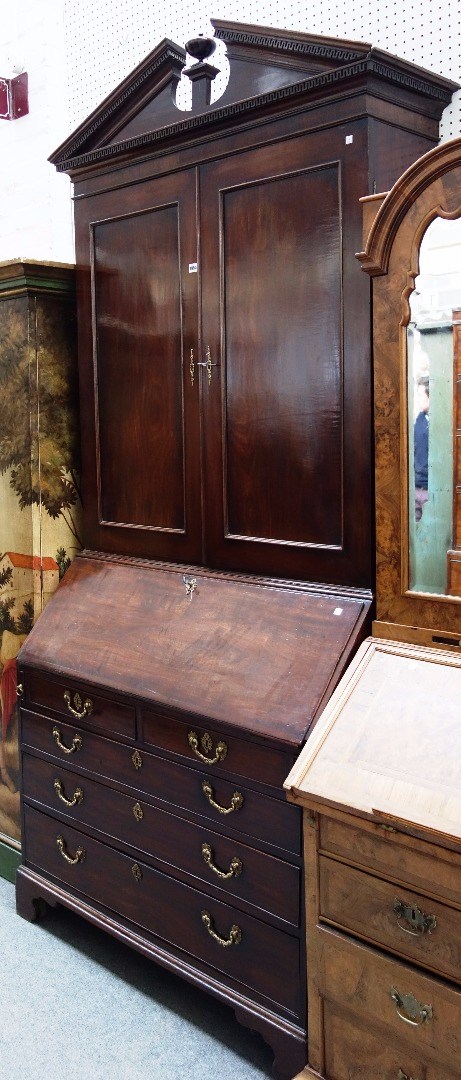 Appraisal: A George III mahogany bureau bookcase the architectural cornice over