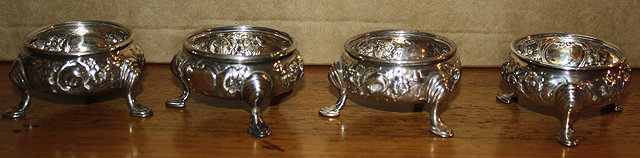 Appraisal: A SET OF FOUR VICTORIAN SILVER BUN SALTS with chased