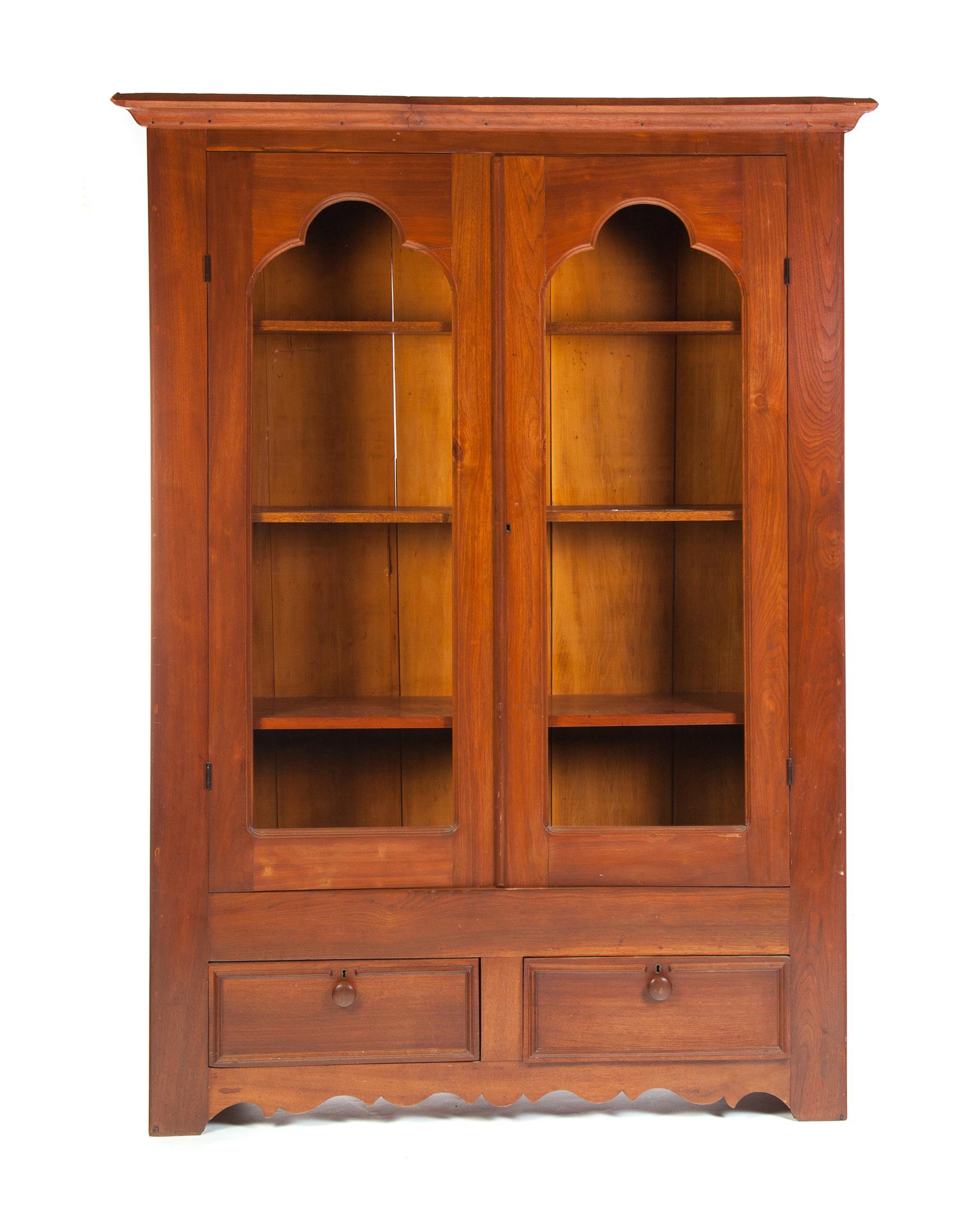 Appraisal: ONE-PIECE WALNUT TWO-DOOR BOOKCASE American rd quarter- th century Molded