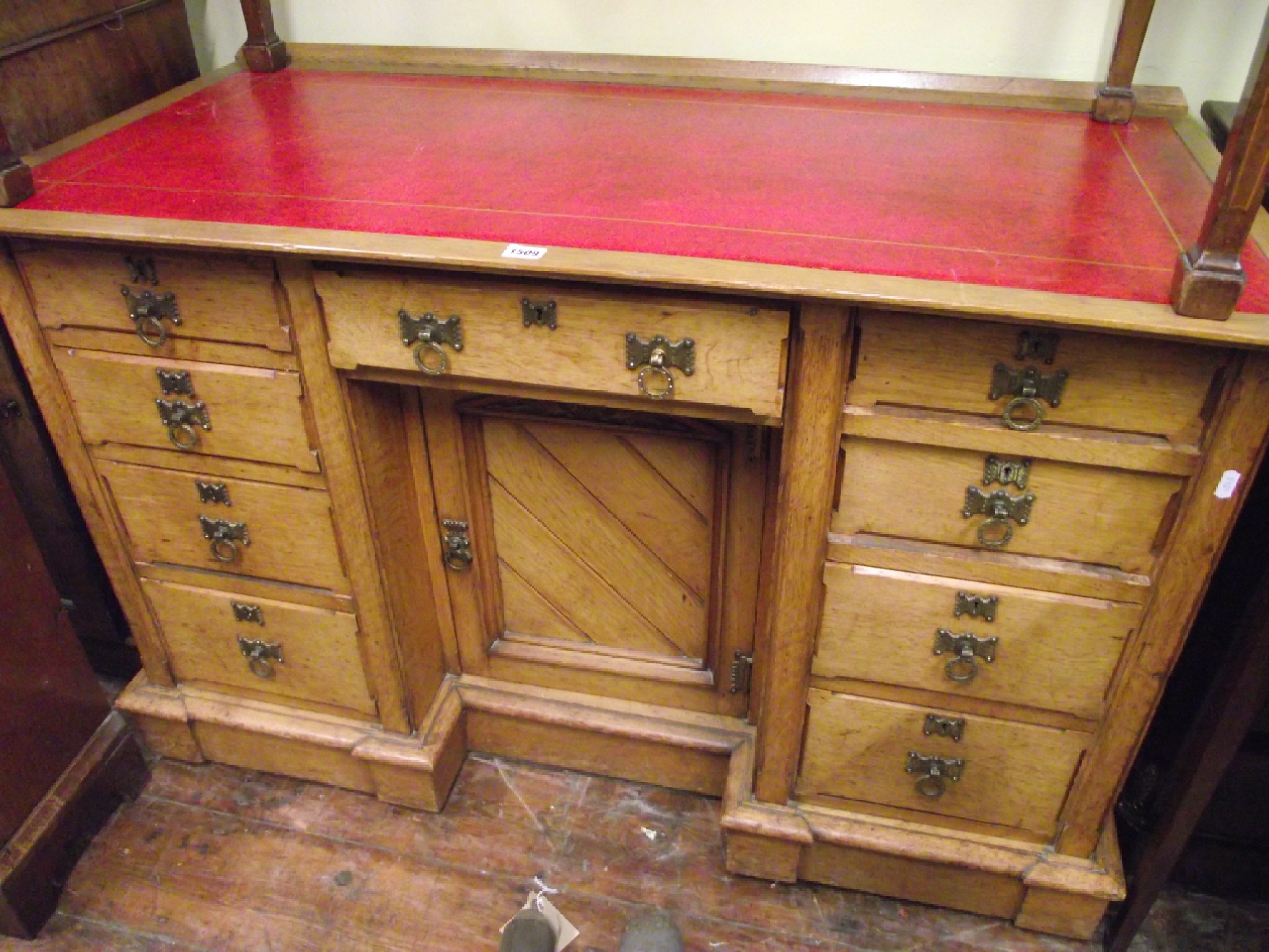 Appraisal: A Victorian Gothic oak inverted breakfront writing desk fitted with