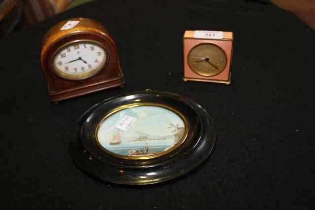 Appraisal: A BRASS CASED TIMEPIECE in the Art Deco style of