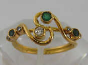 Appraisal: An Italian carat yellow gold diamond and emerald ring finger