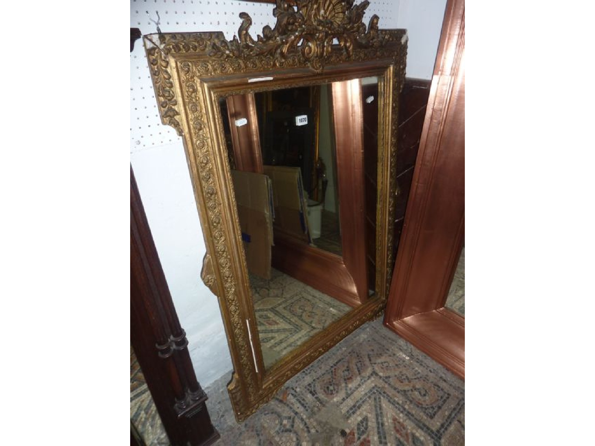 Appraisal: A th century gilded wall mirror of rectangular form with