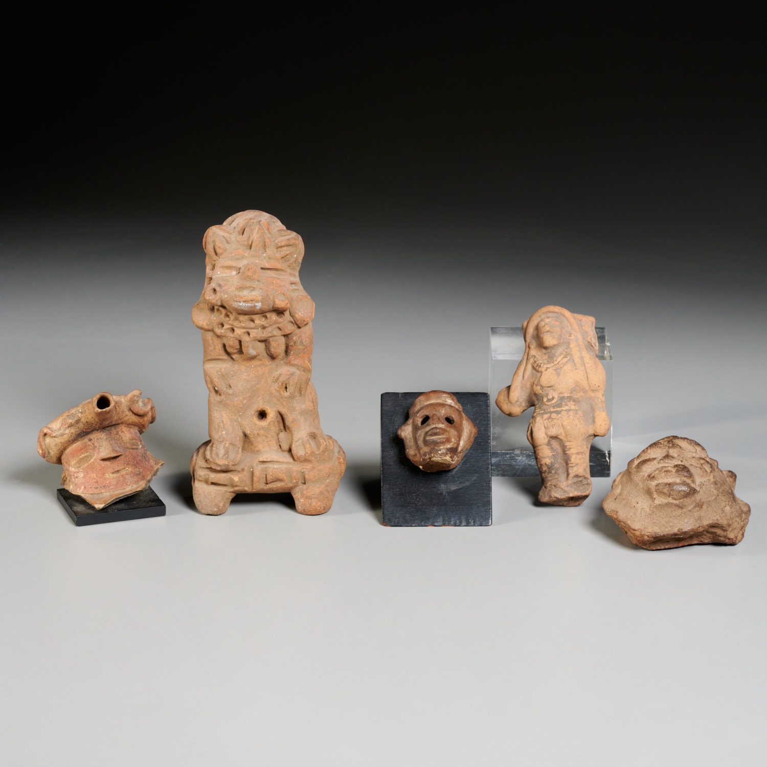 Appraisal: PRE-COLUMBIAN CARVED EARTHENWARE ANTIQUITIES pieces incl figures and head fragments