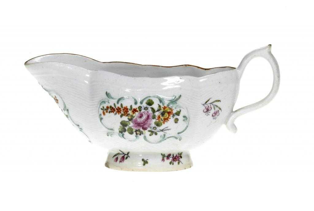 Appraisal: A DERBY SAUCE BOAT moulded with rococo panels reserved on