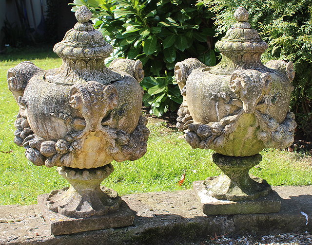 Appraisal: A PAIR OF RECONSTITUTED CAST FINIALS of ovoid lidded classical