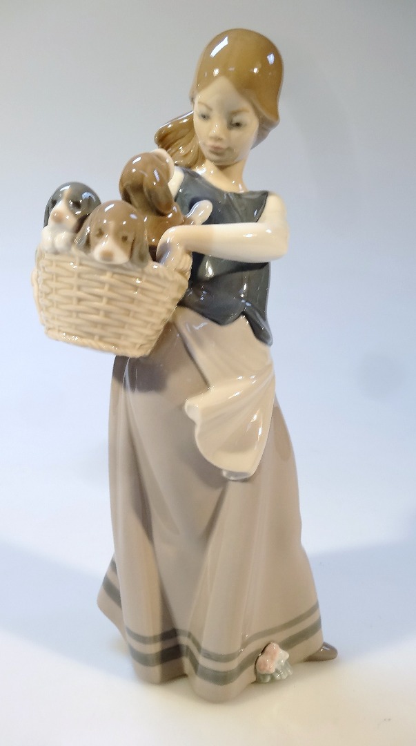 Appraisal: A Lladro figure of a girl in flowing dress holding