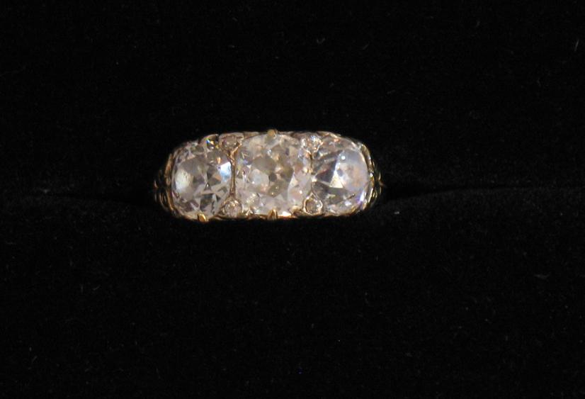 Appraisal: A VICTORIAN THREE STONE DIAMOND RING the large central old-cut