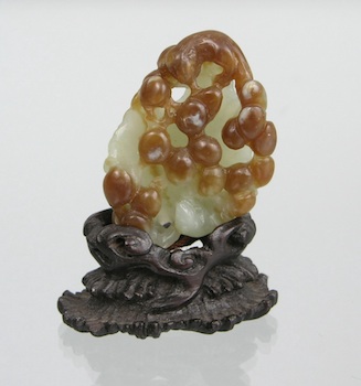 Appraisal: A Carved Jade Ornament on Wood Stand Chinese A small