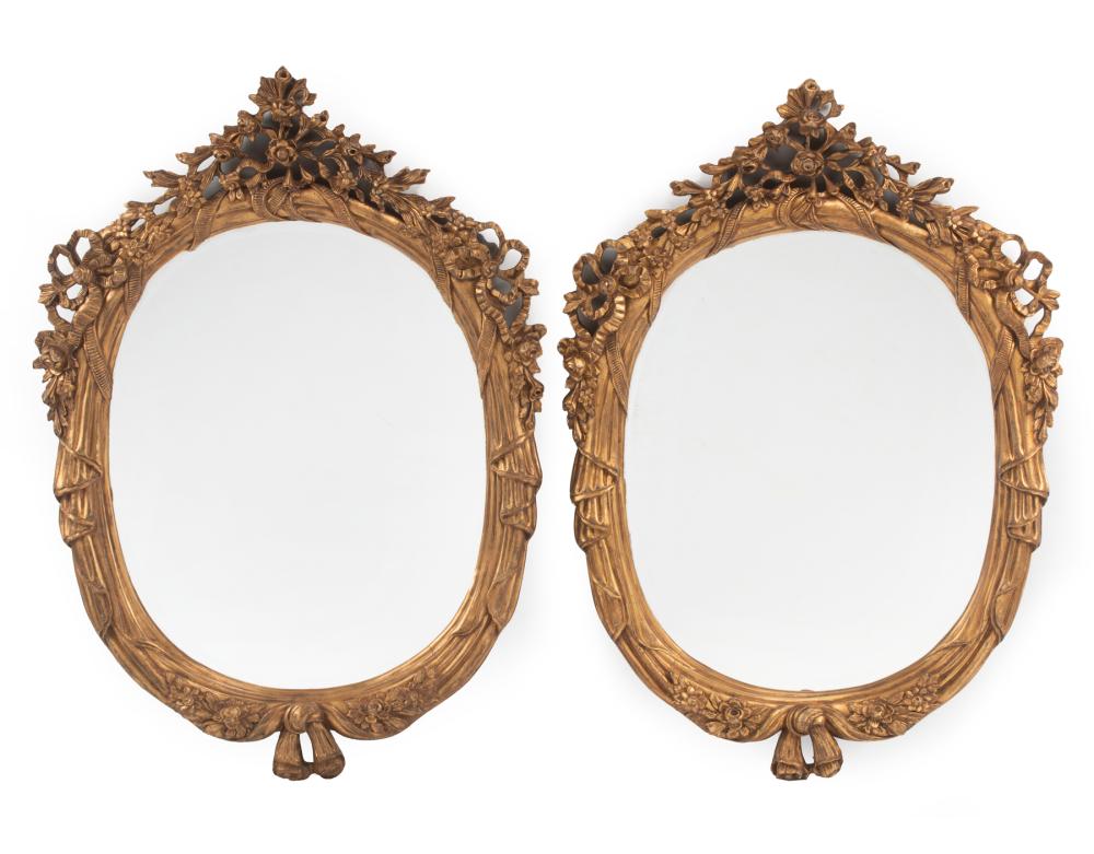 Appraisal: Pair of Italian Rococo-Style Carved Giltwood Oval Mirrors draped surround