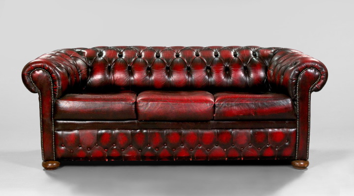 Appraisal: Oxblood Leather Chesterfield the tufted back wrapping around to similarly