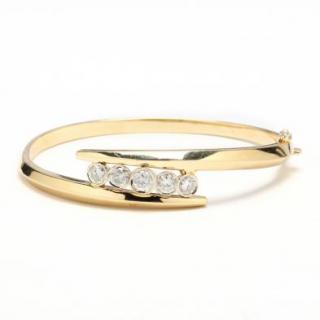 Appraisal: KT Gold and Diamond Bracelet the hinged bangle bracelet in