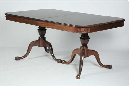 Appraisal: DINING TABLE Mahogany double pedastal table with carved corners and