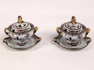 Appraisal: PAIR OF IRONSTONE COVERED TUREENS WITH MATCHING UNDERPLATES HAVING POMEGRANATE