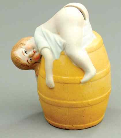 Appraisal: RESTING BABY ON BARREL STILL BANK Porcelain whimsical depiction of