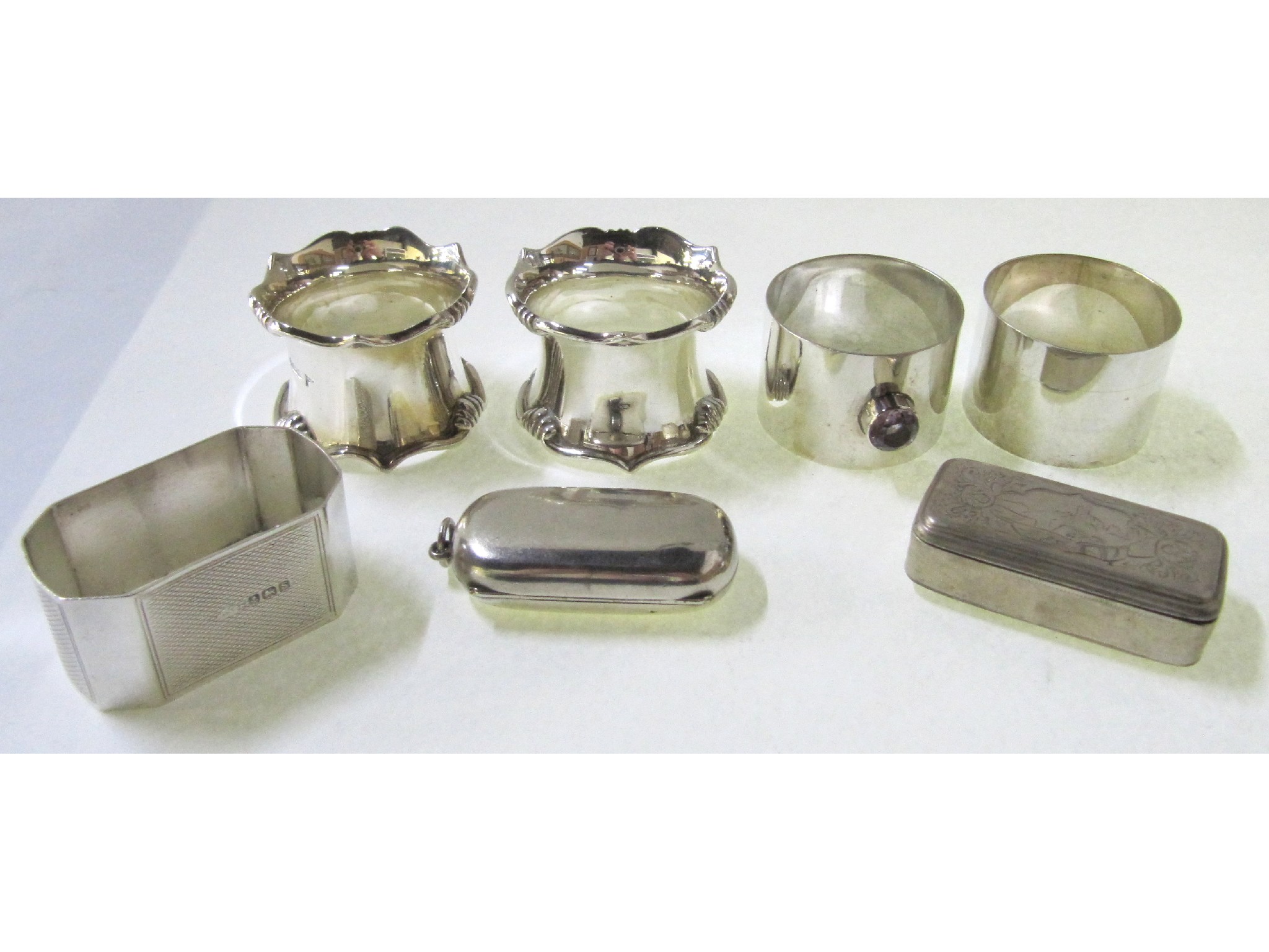 Appraisal: A lot comprising two pairs of silver napkin rings a