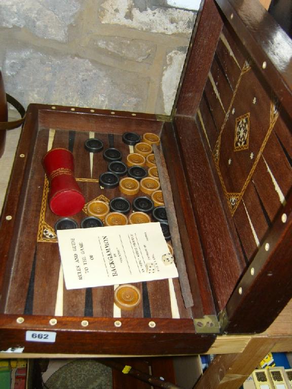 Appraisal: A mahogany cased backgammon set with specimen wood and ivory