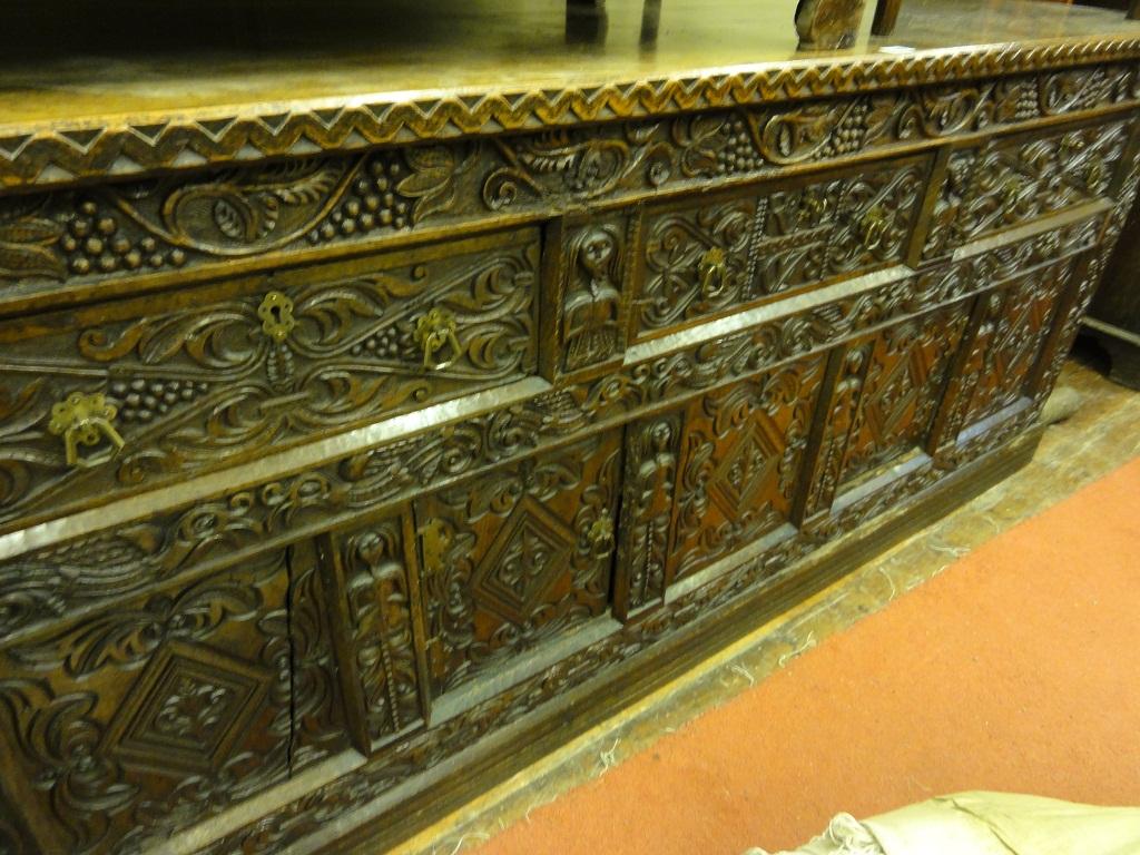 Appraisal: An antique oak dresser base with profusely carved front elevation