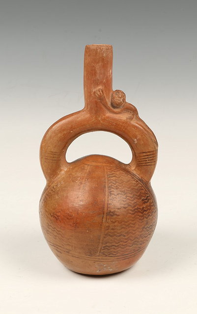 Appraisal: A REDWARE STIRRUP VESSEL the handle modelled with a monkey