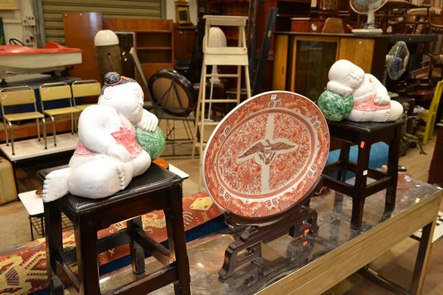 Appraisal: A PAIR OF JAPANESE WOODEN FIGURES OF KIDS LYING DOWN