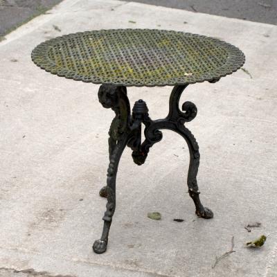 Appraisal: A pierced cast iron garden tabletop on an associated tripod