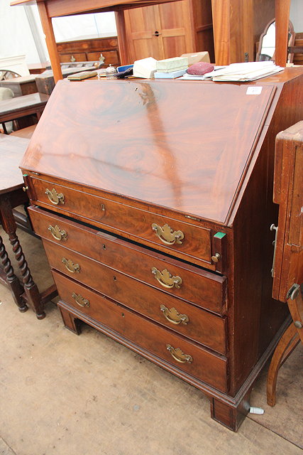 Appraisal: A GEORGE III MAHOGANY AND OAK BUREAU fall front opening