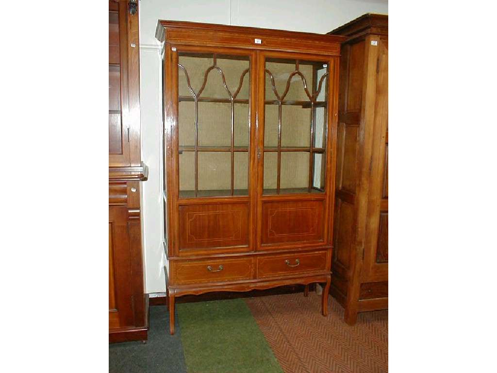 Appraisal: An Edwardian string inlaid mahogany two door display cabinet with