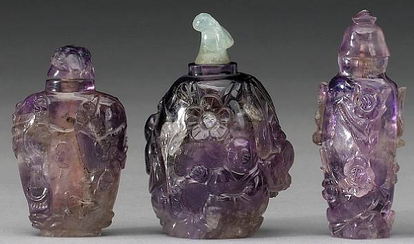 Appraisal: Three carved amethyst snuff bottles The first carved with a