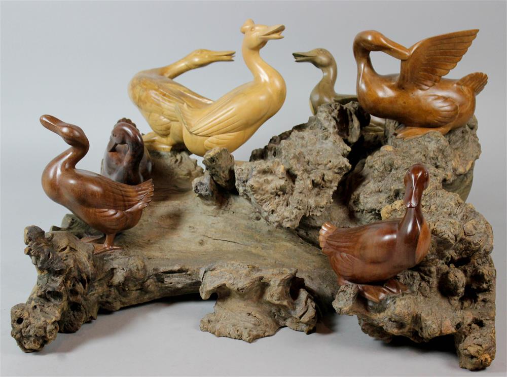 Appraisal: SOUTHEAST ASIAN CARVED DUCK GROUP ON ROOTWOOD the natural piece