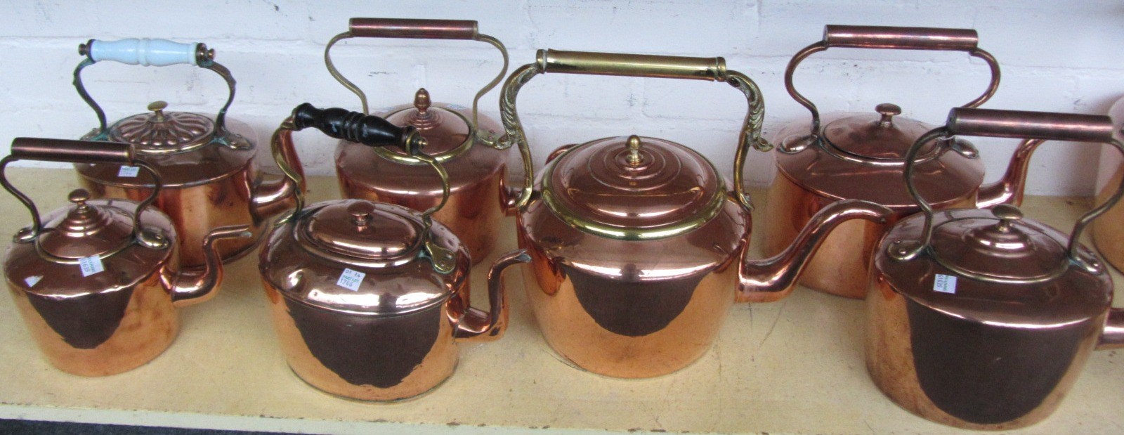 Appraisal: A group of eleven copper kettles th century the tallest