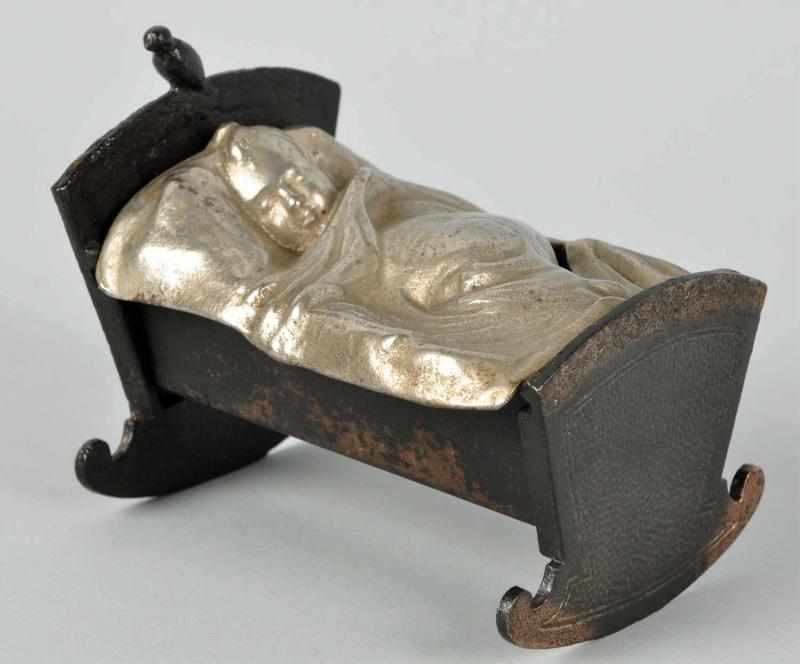 Appraisal: Cast Iron Baby in Cradle Still Bank Description Circa s