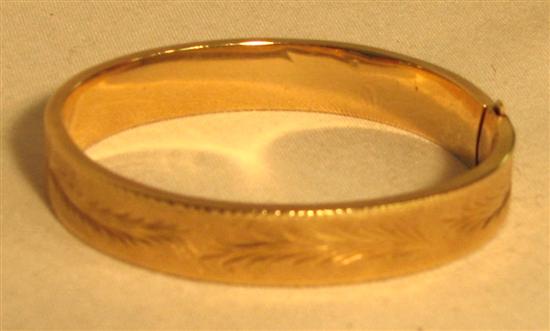 Appraisal: JEWELRY Wide engraved bangle bracelet K yellow gold leaf design