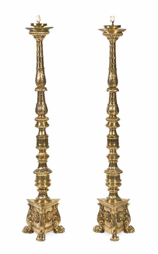 Appraisal: A Pair of Empire Style Brass Torchieres having baluster leaf