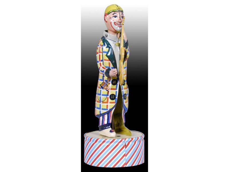 Appraisal: German Tin Wind-Up Clown Playing Guitar Toy Description - ''