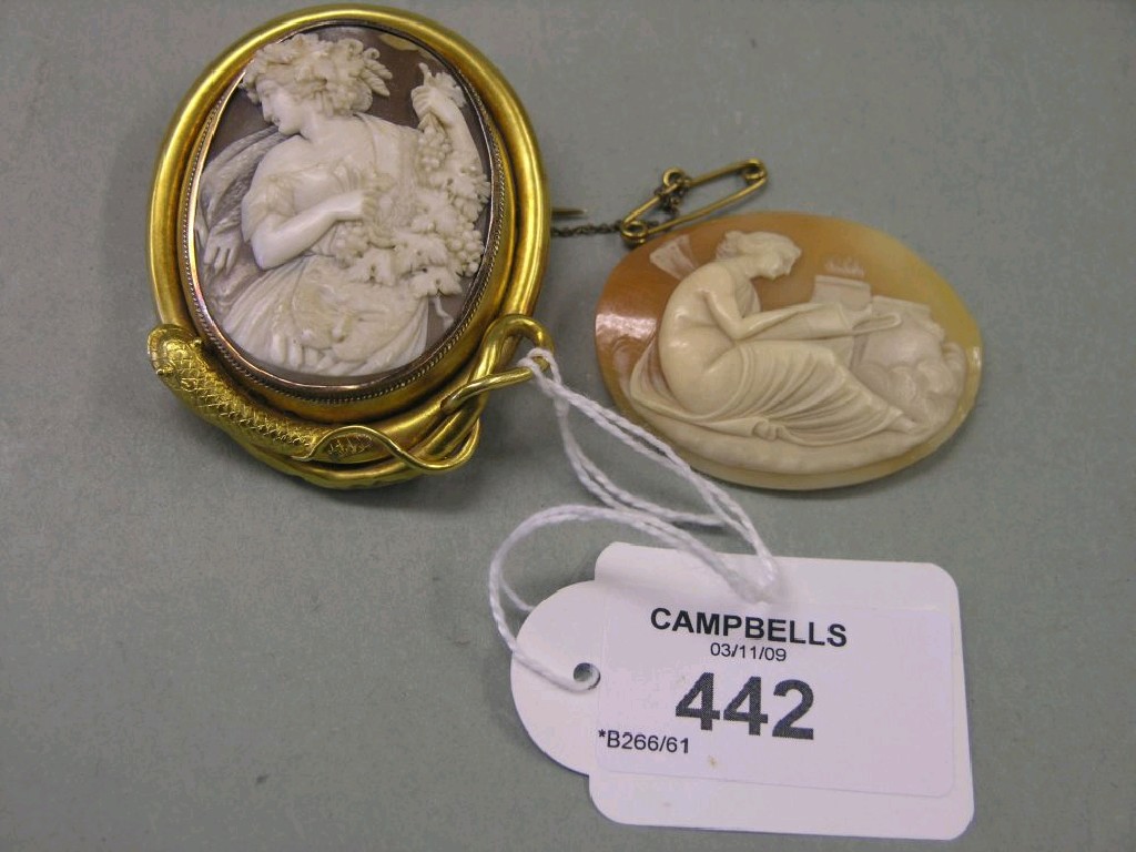 Appraisal: A large cameo carved with a maiden carrying grapevine within