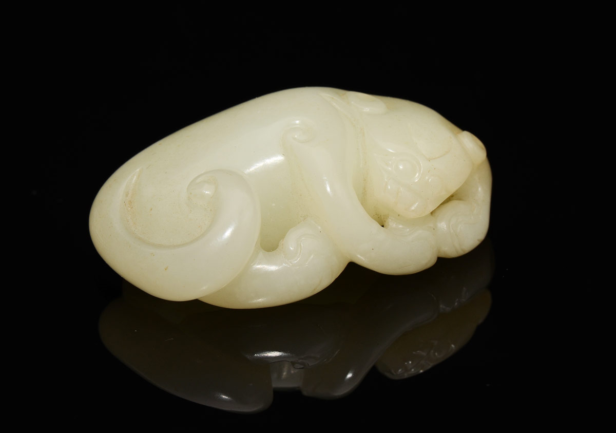 Appraisal: CHINESE CARVED WHITE JADE FIGURE OF RECUMBENT LION '' long