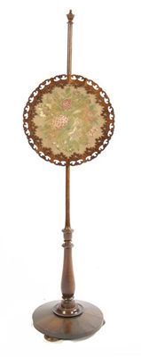 Appraisal: A Victorian rosewood pole fire screen with a floral needlework