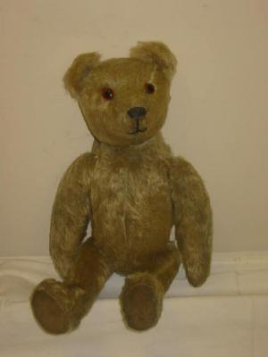 Appraisal: A pre-war English teddy bear straw filled covered in pale